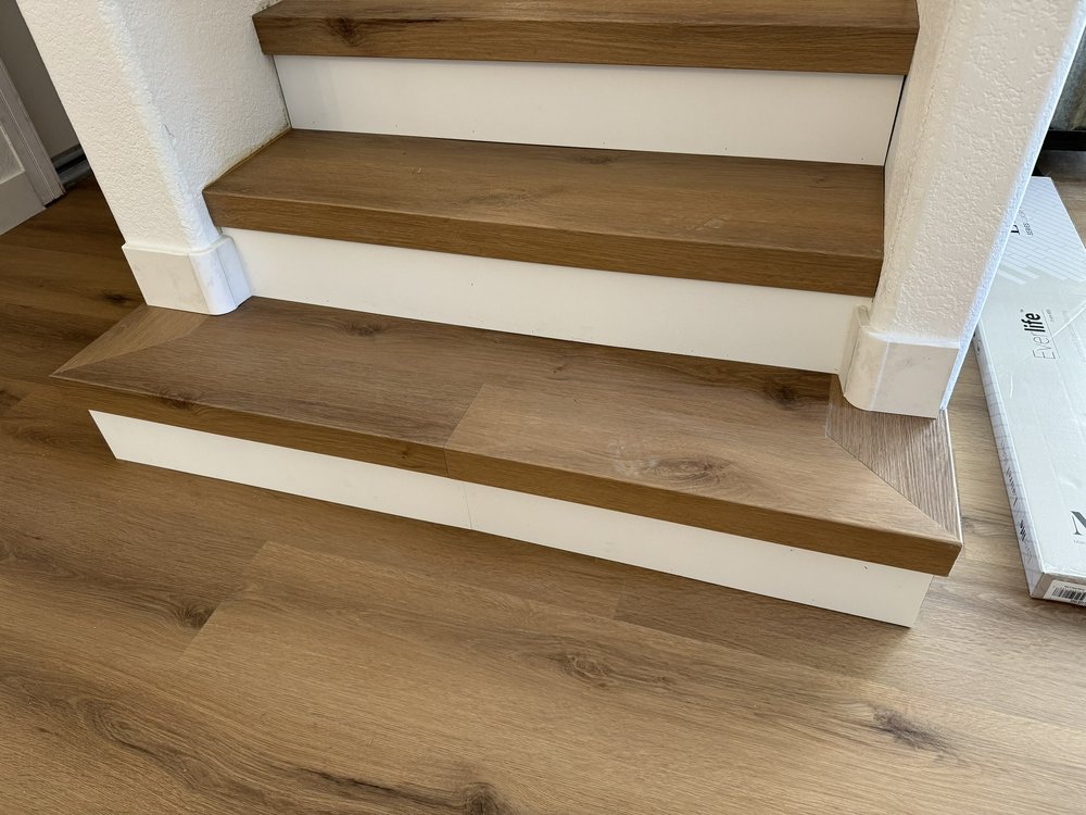 Warm wood stair treads with crisp white risers
