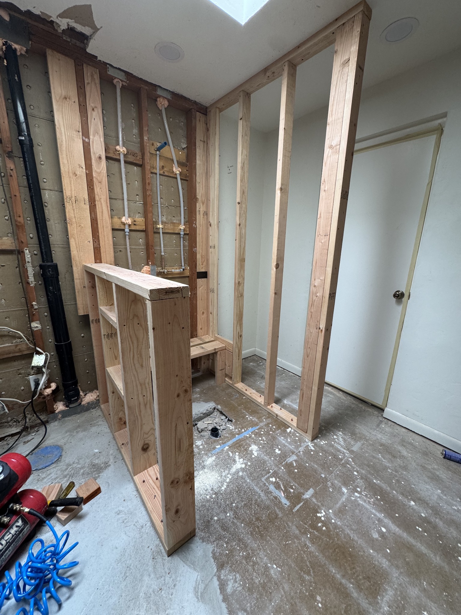 Custom shower renovation during new wall and half-wall framing