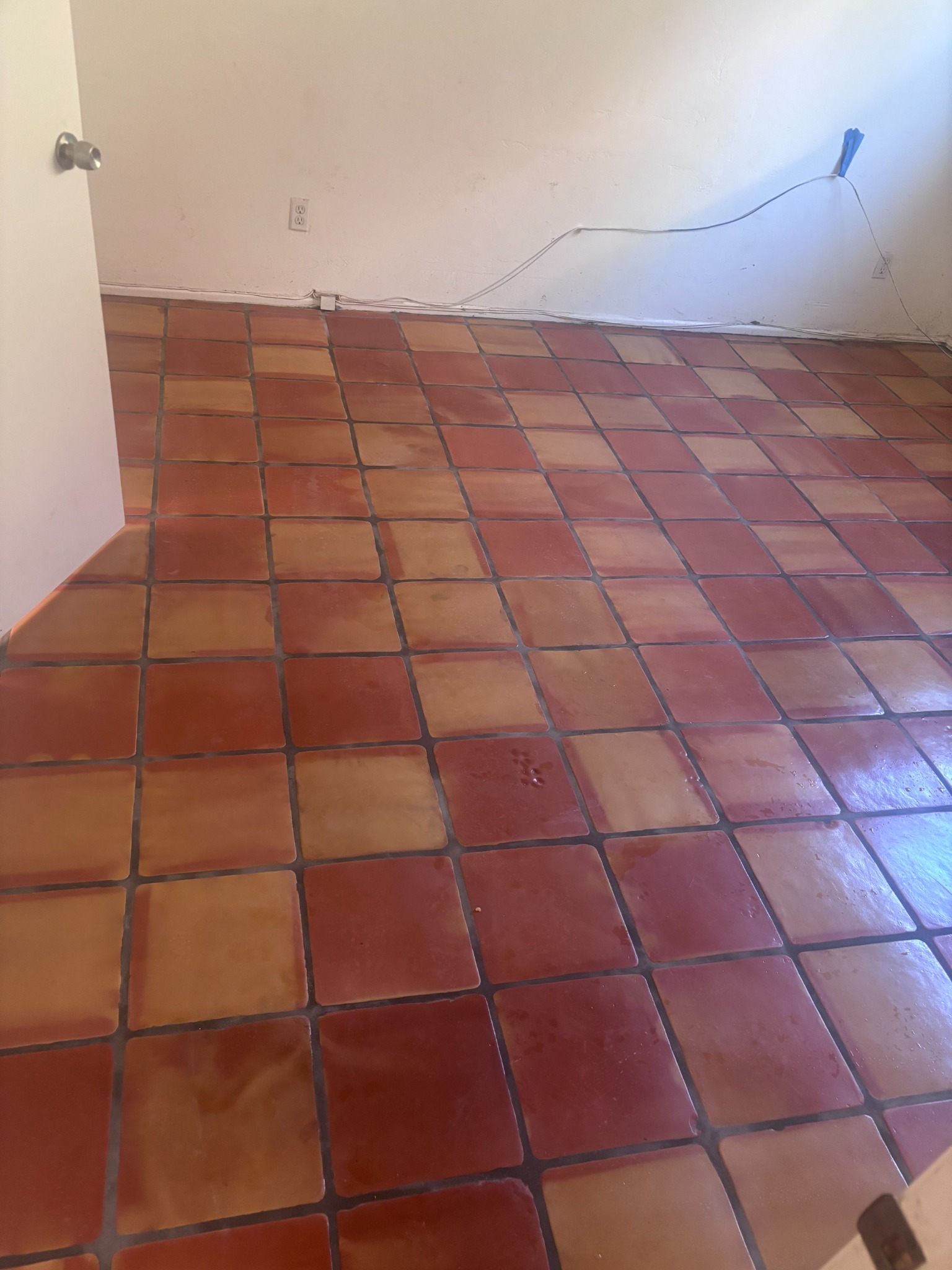 Completed Saltillo tile flooring with warm red and golden natural color variation